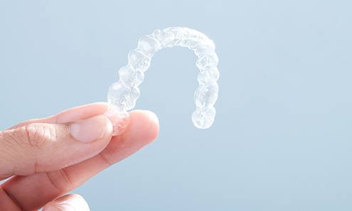 Patient holding clear aligner