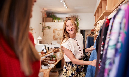 Woman smiling while shopping with friend in store