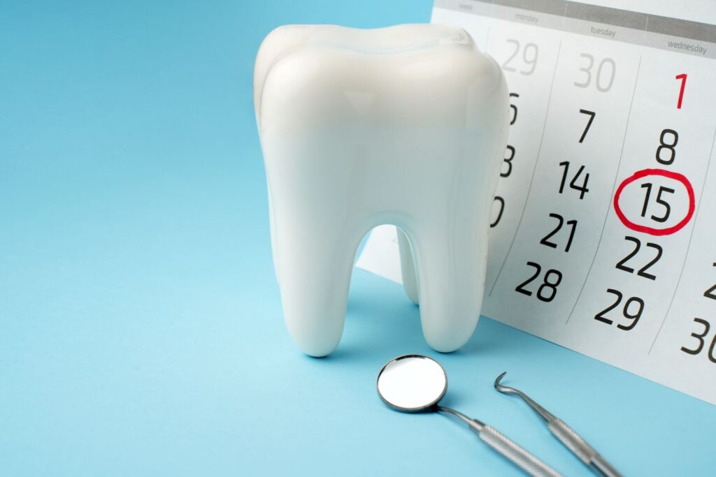 A tooth next to a calendar