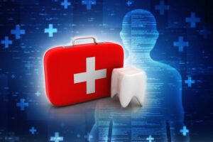 Dental emergency kit next to a tooth model